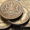 A pile of one pound coins is seen in central London